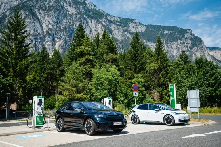 Elektroautos laden an Schnellladesäulen in alpiner Berglandschaft, Österreich